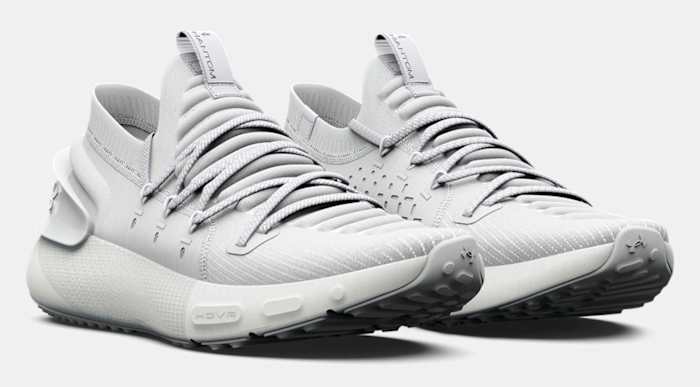 Side view of grey Under Armour running shoes.